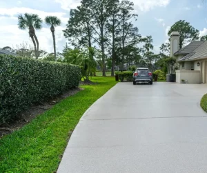 polyurea coated driveway with a car and palm trees