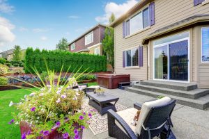 Cozy patio area with settees and table, decorated with flower pot