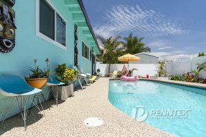 light blue pool with polyurea flake concrete sealer around the pool